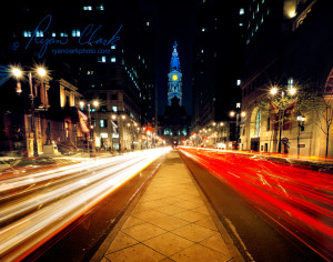 Streaks of light from cars passing to and fro with City Hall in the background. The effect is made by a long camera exposure.