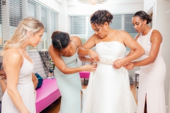 The Bridesmaids Helping the Bride Dress